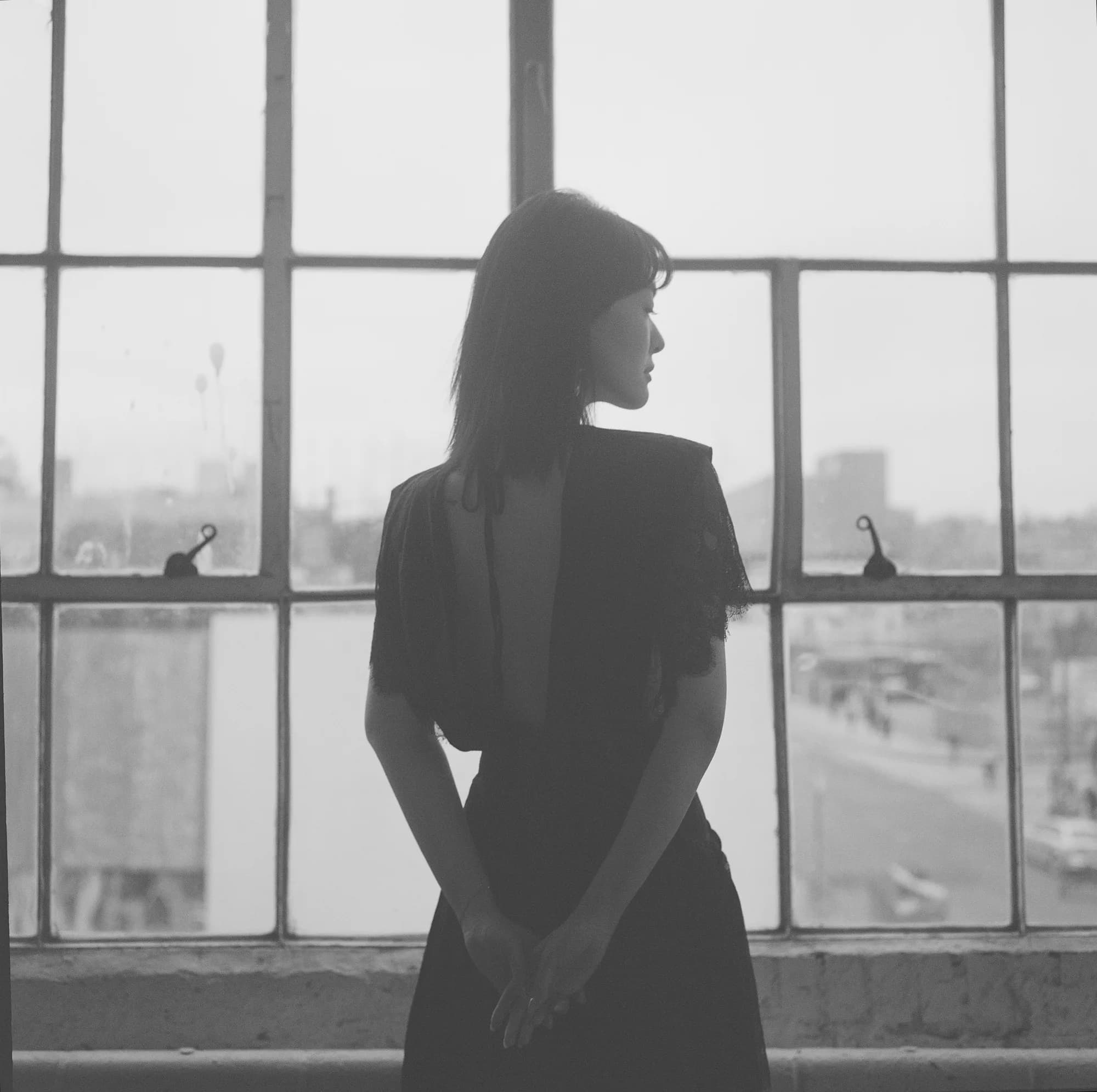 A monochrome profile beside a gridded window.