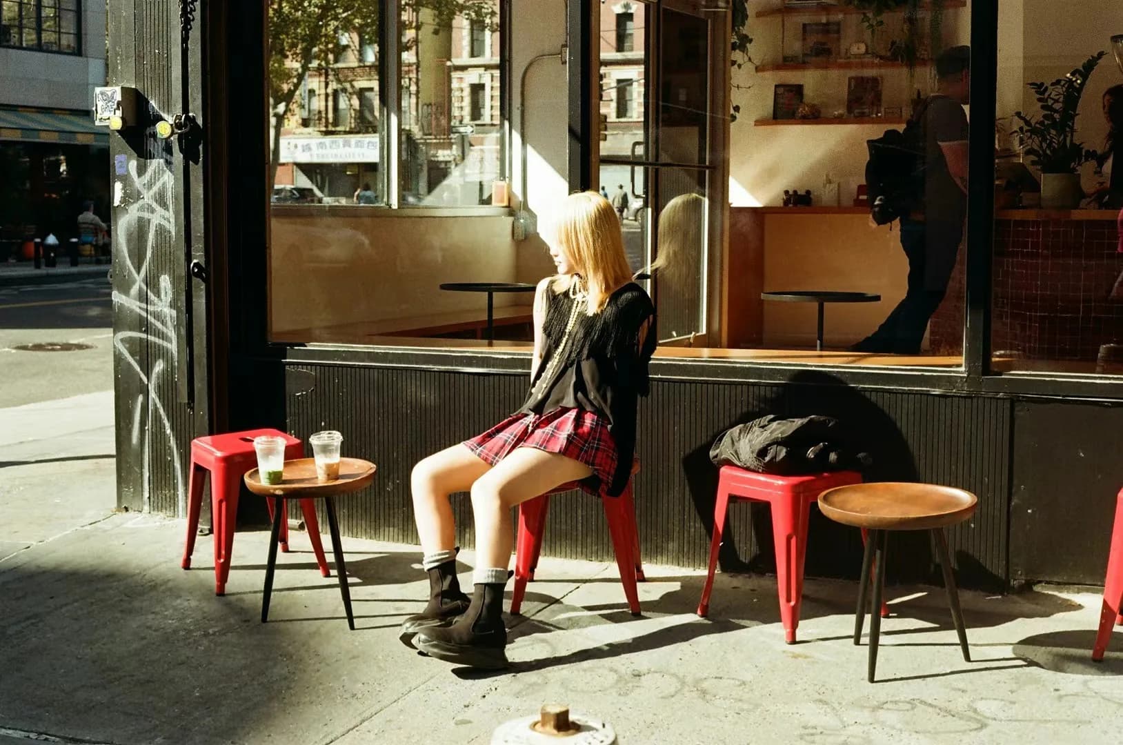 Cafe tables in warm street light.