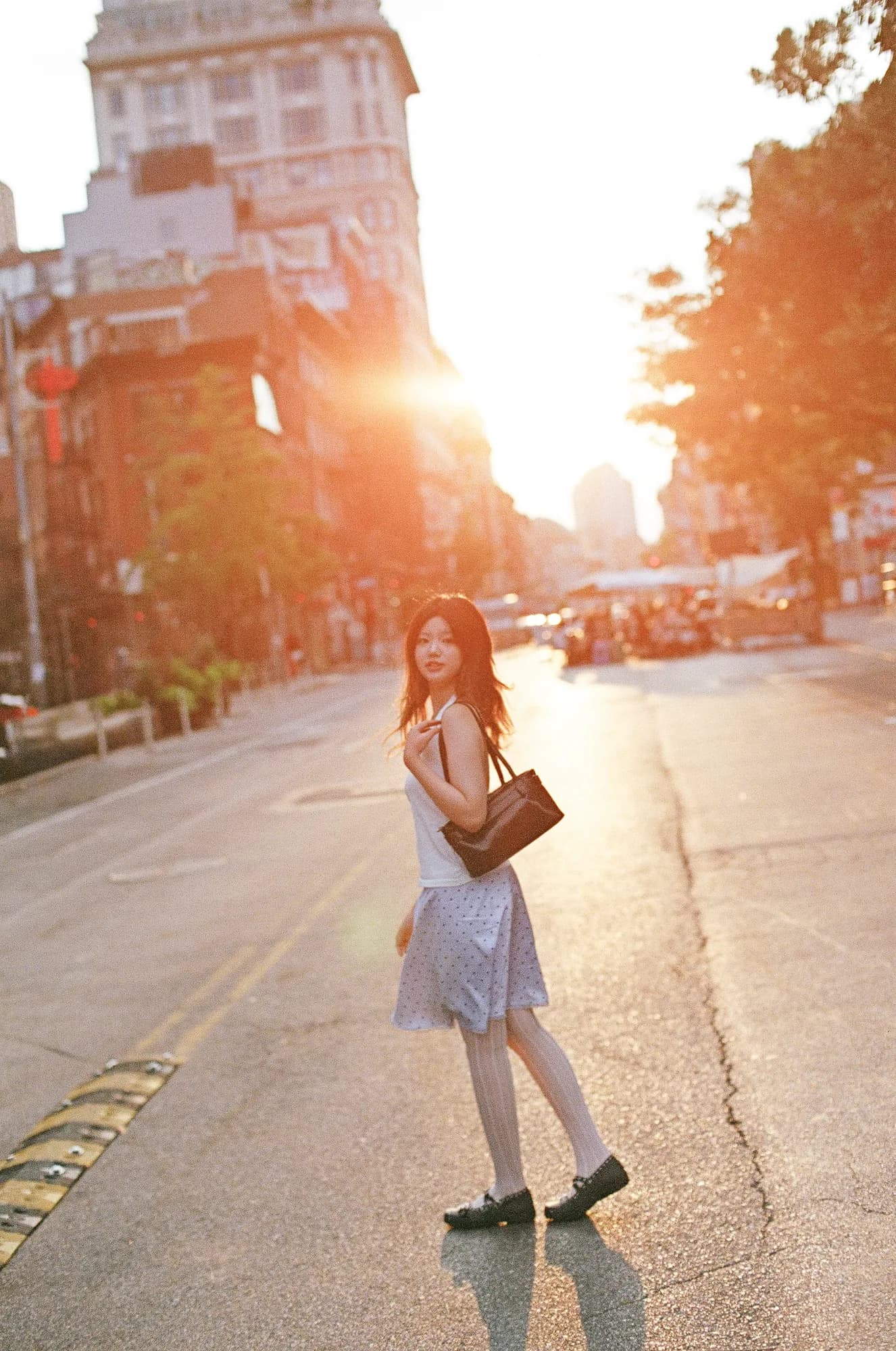 A sunlit figure on a city street.