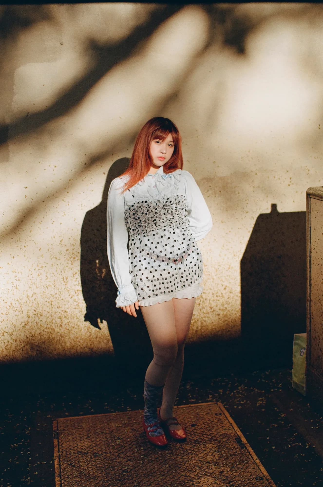 A patterned dress against a warm wall.