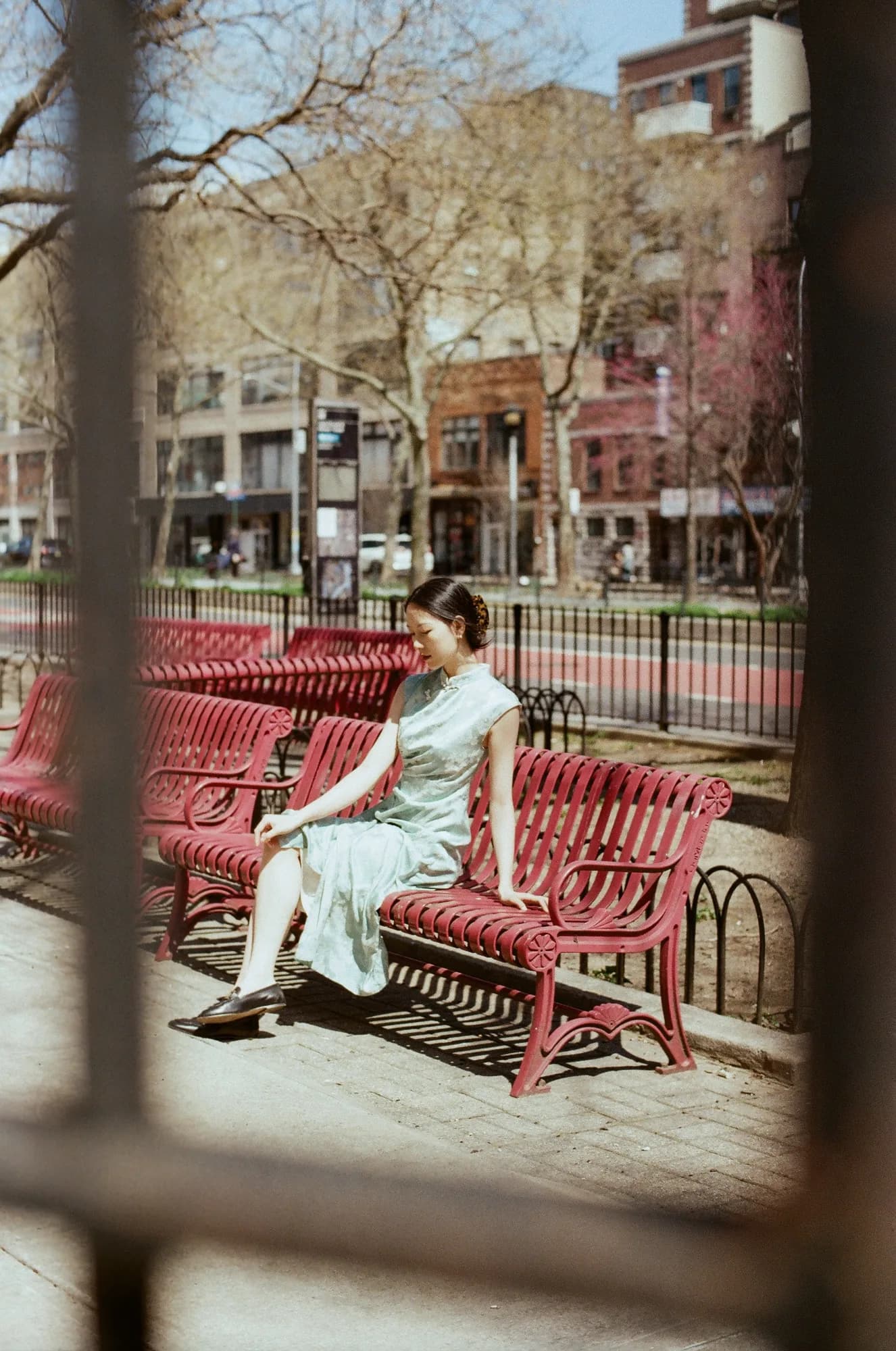 Mint clothing beside a red bench.