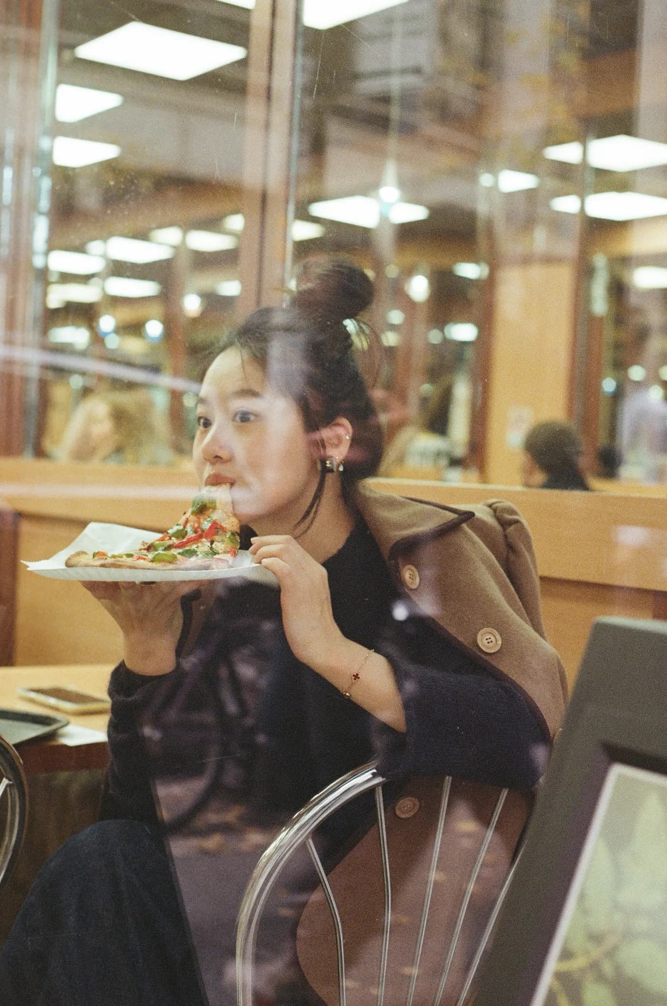 A portrait in a warm cafe interior.