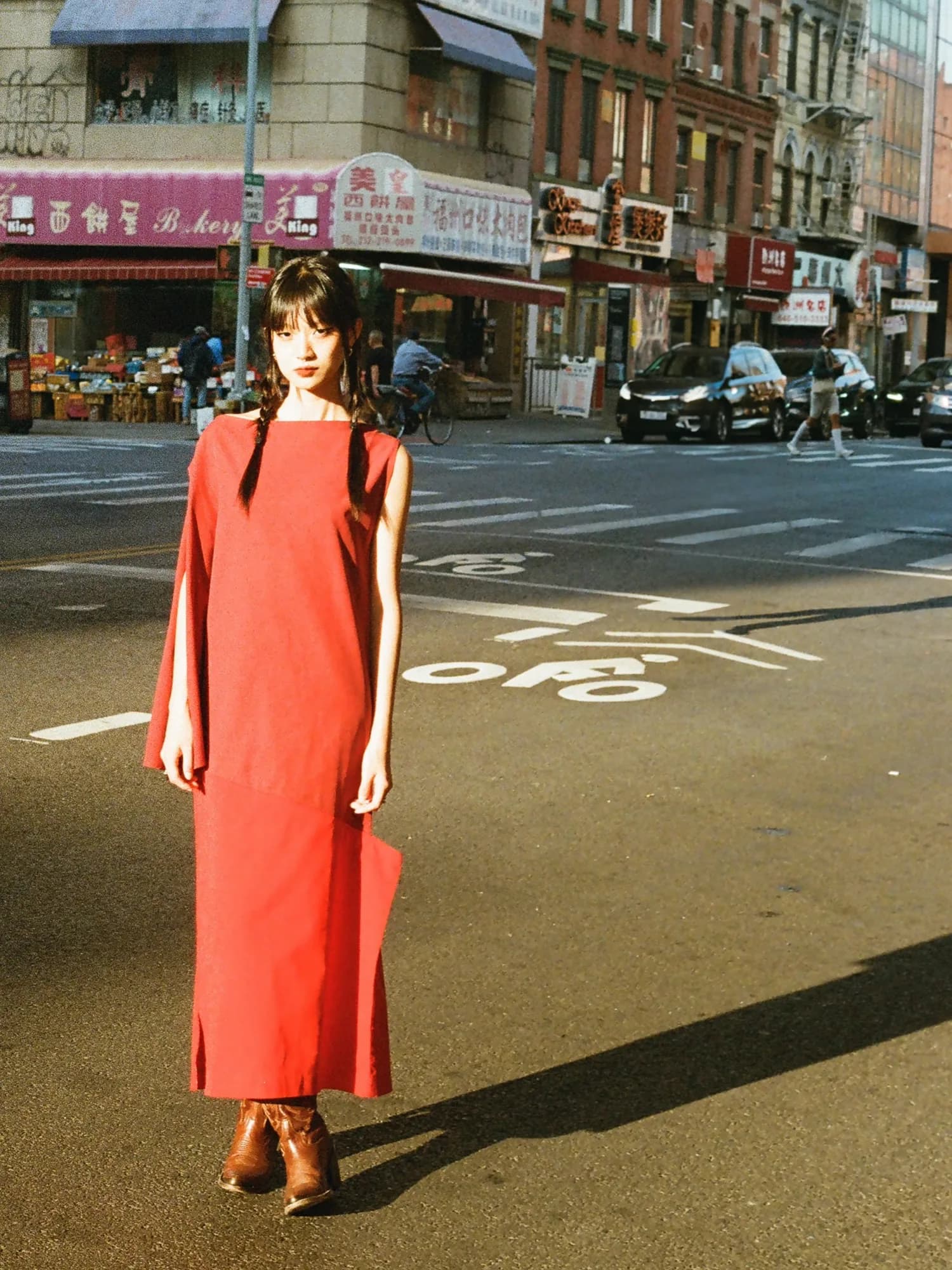 A red dress and long street shadow.