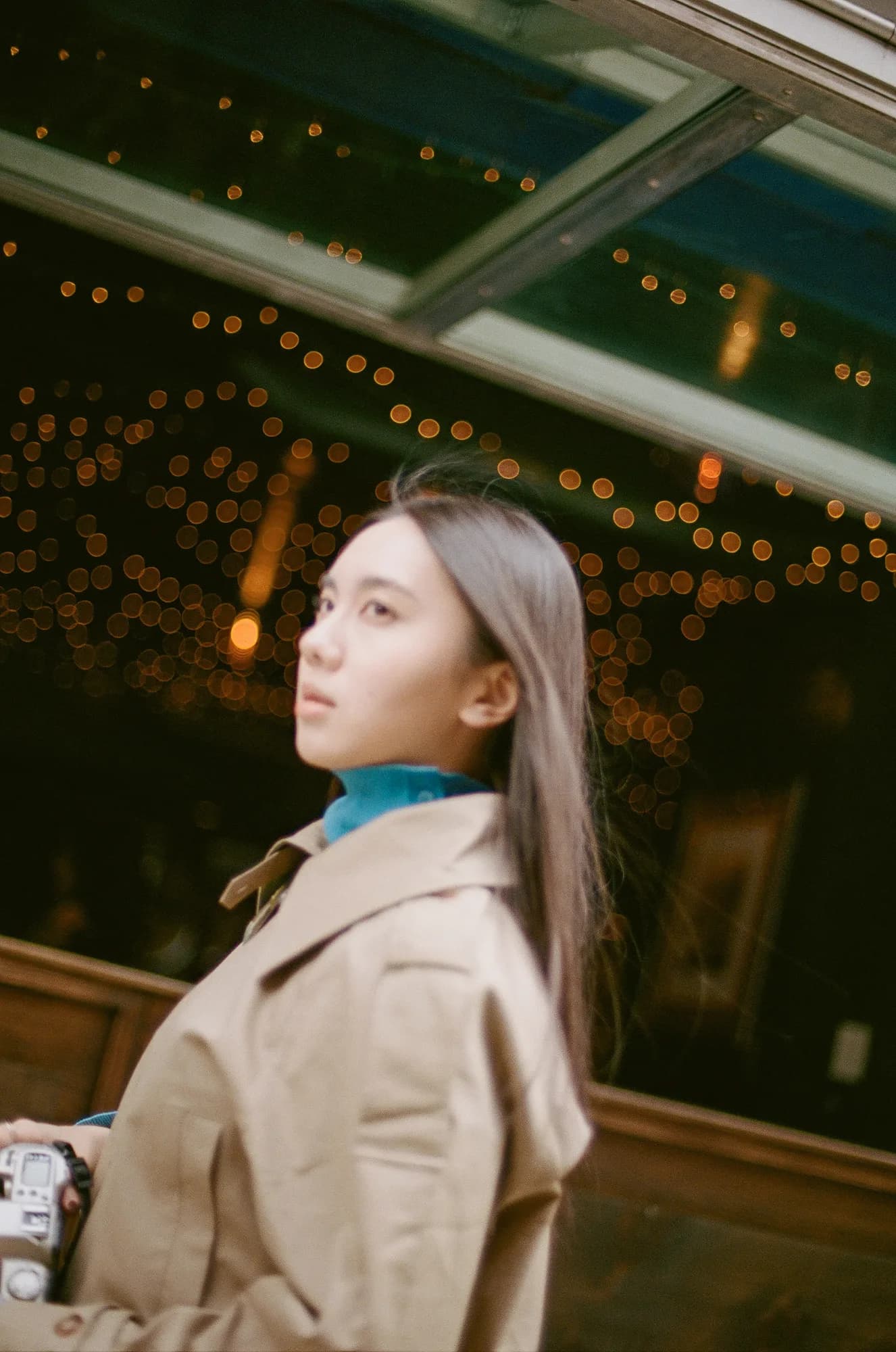 A portrait beneath dark green lights.