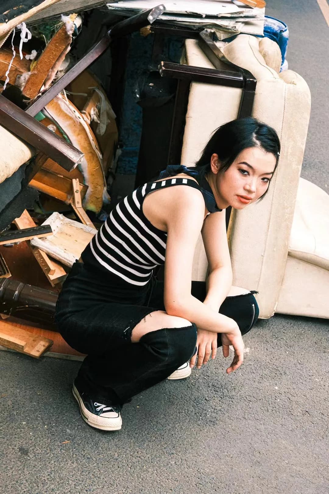 A striped outfit beside a wooden bench.