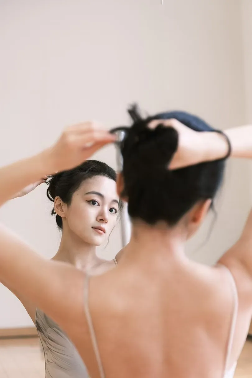 A cream-toned studio mirror portrait.