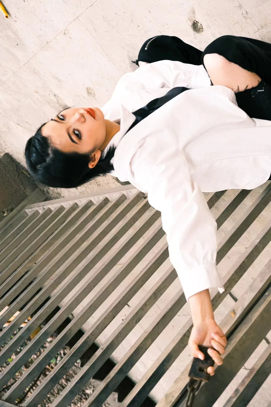 A tilted portrait beside a wooden bench.