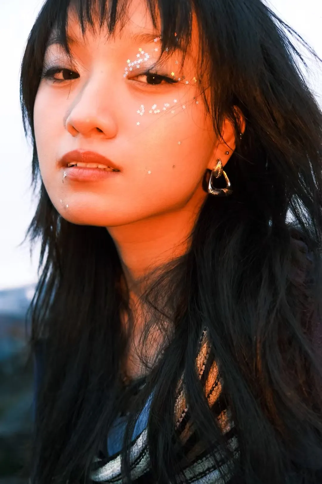 A close portrait in orange light.