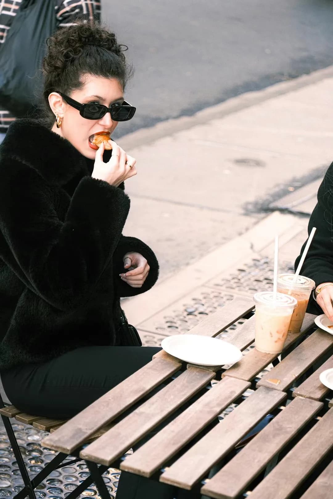 A dark outfit against pale pavement.