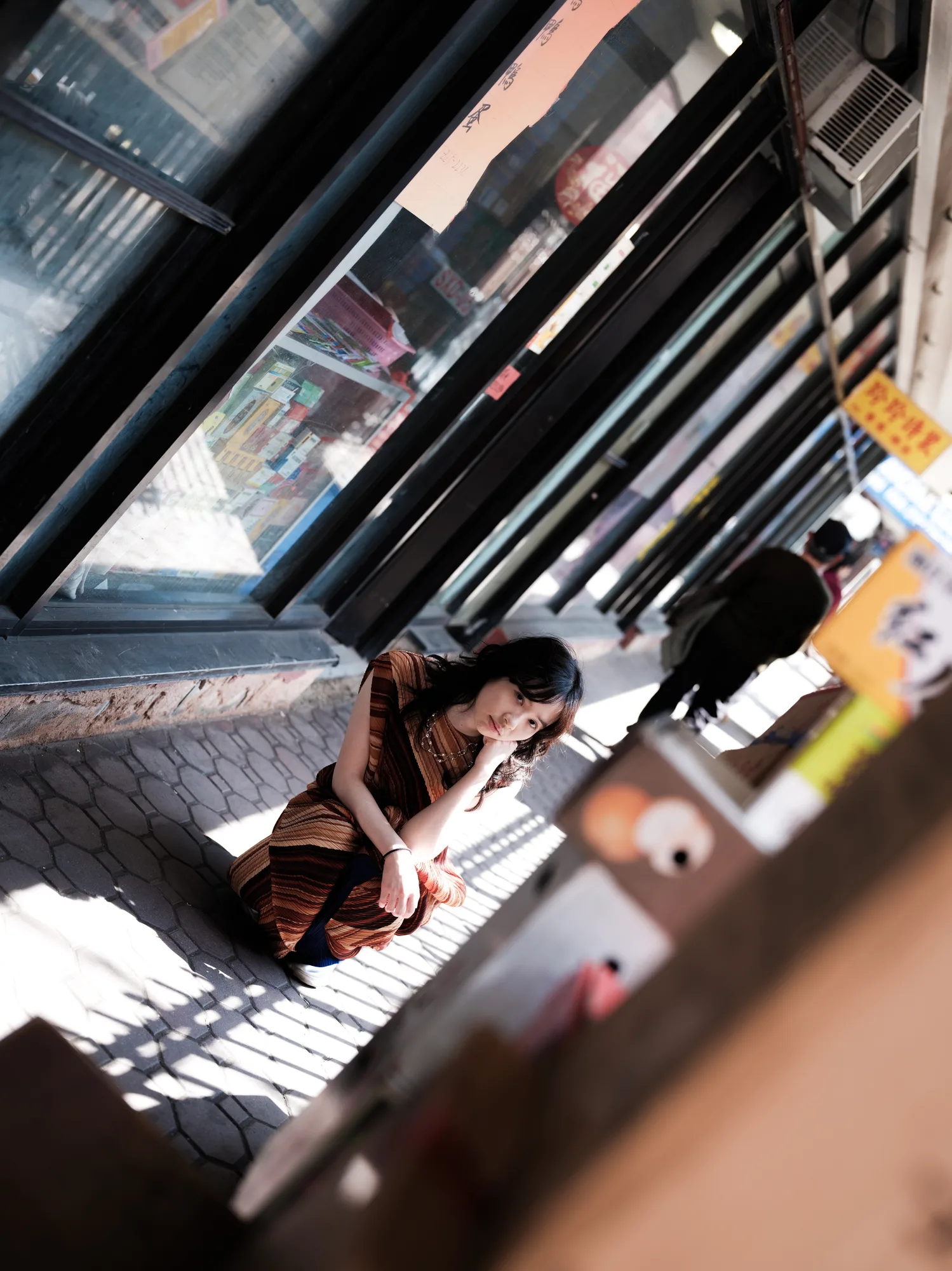 A tilted portrait among escalator reflections.