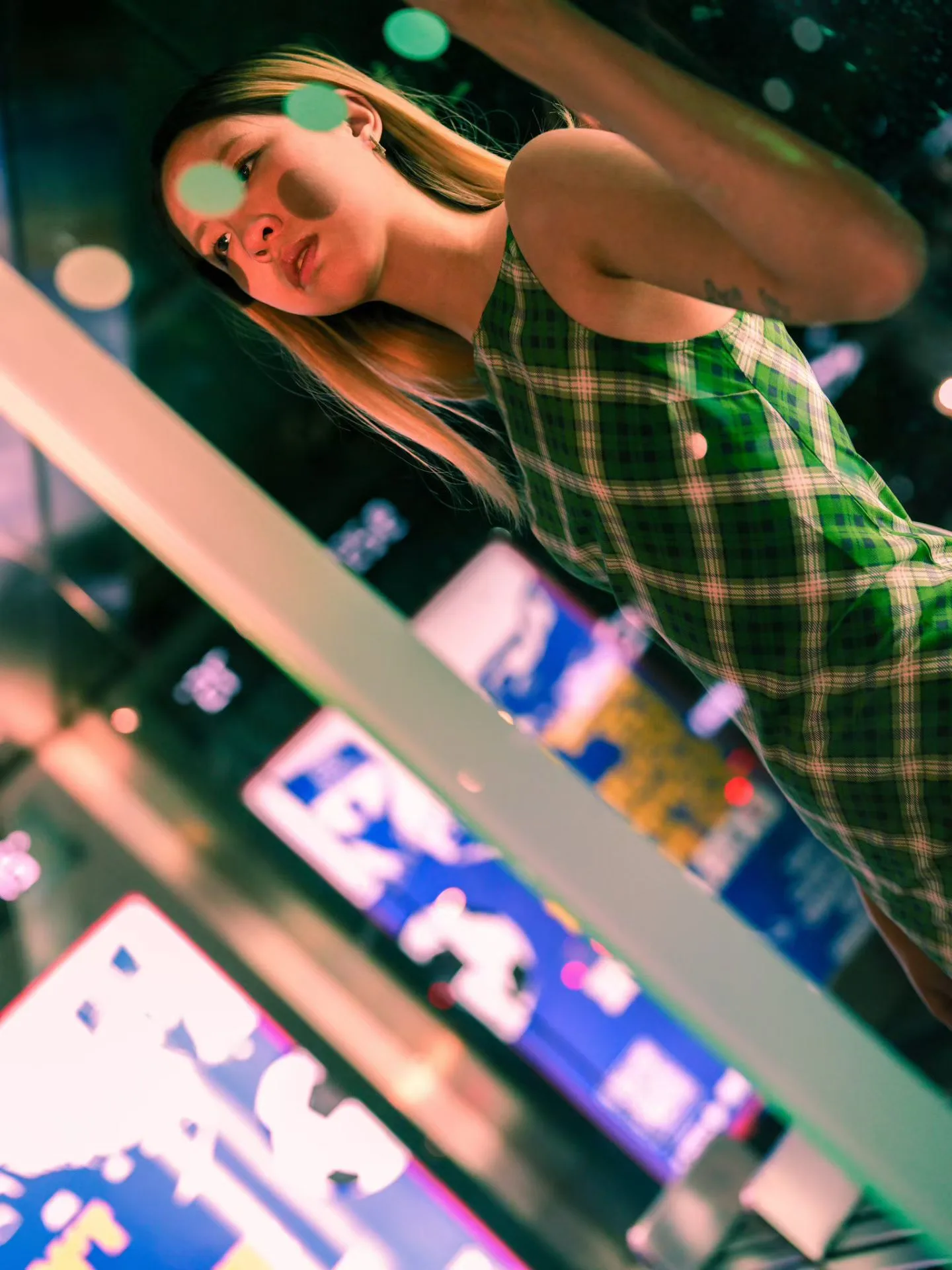 A green checked dress in neon light.