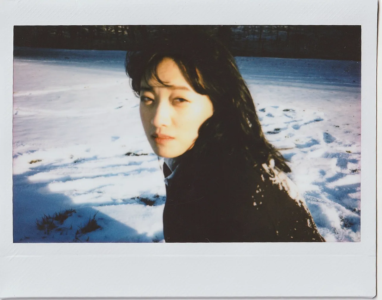 An instant portrait against blue snow shadows.