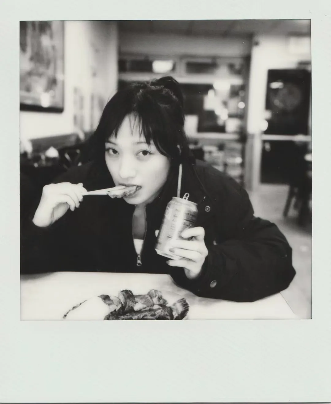 A monochrome instant cafe portrait.