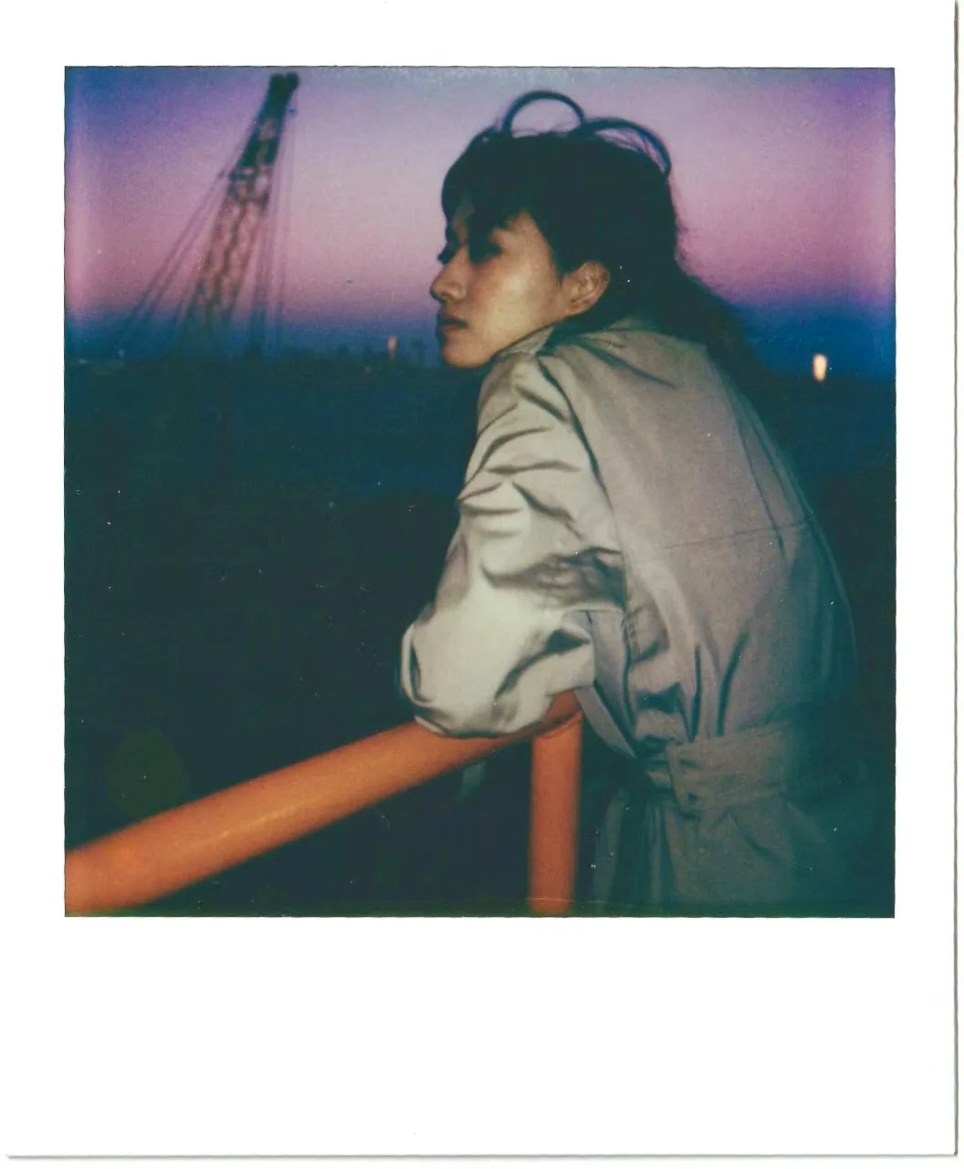 A blue-violet waterfront instant portrait.