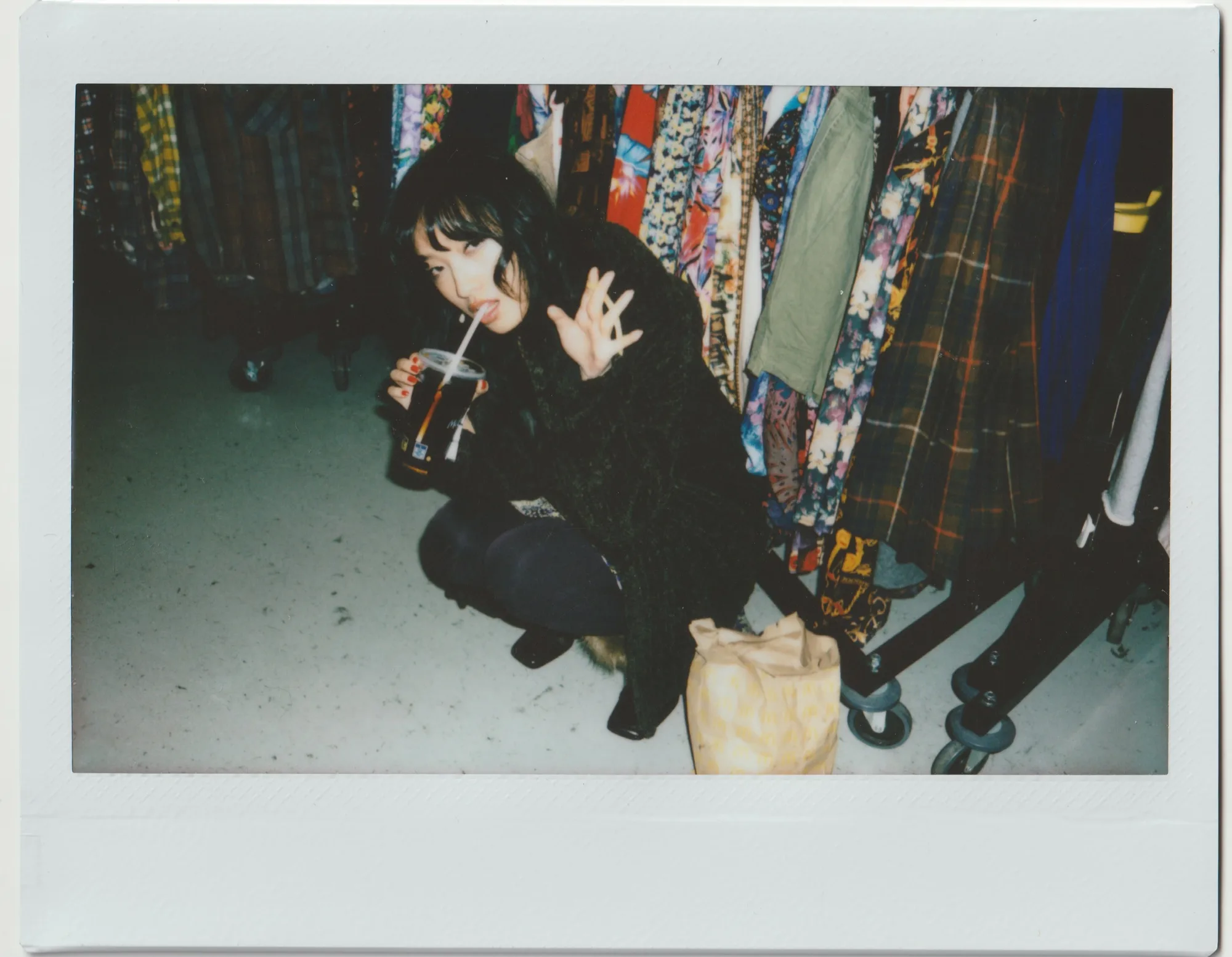 An instant portrait in a colorful clothing shop.